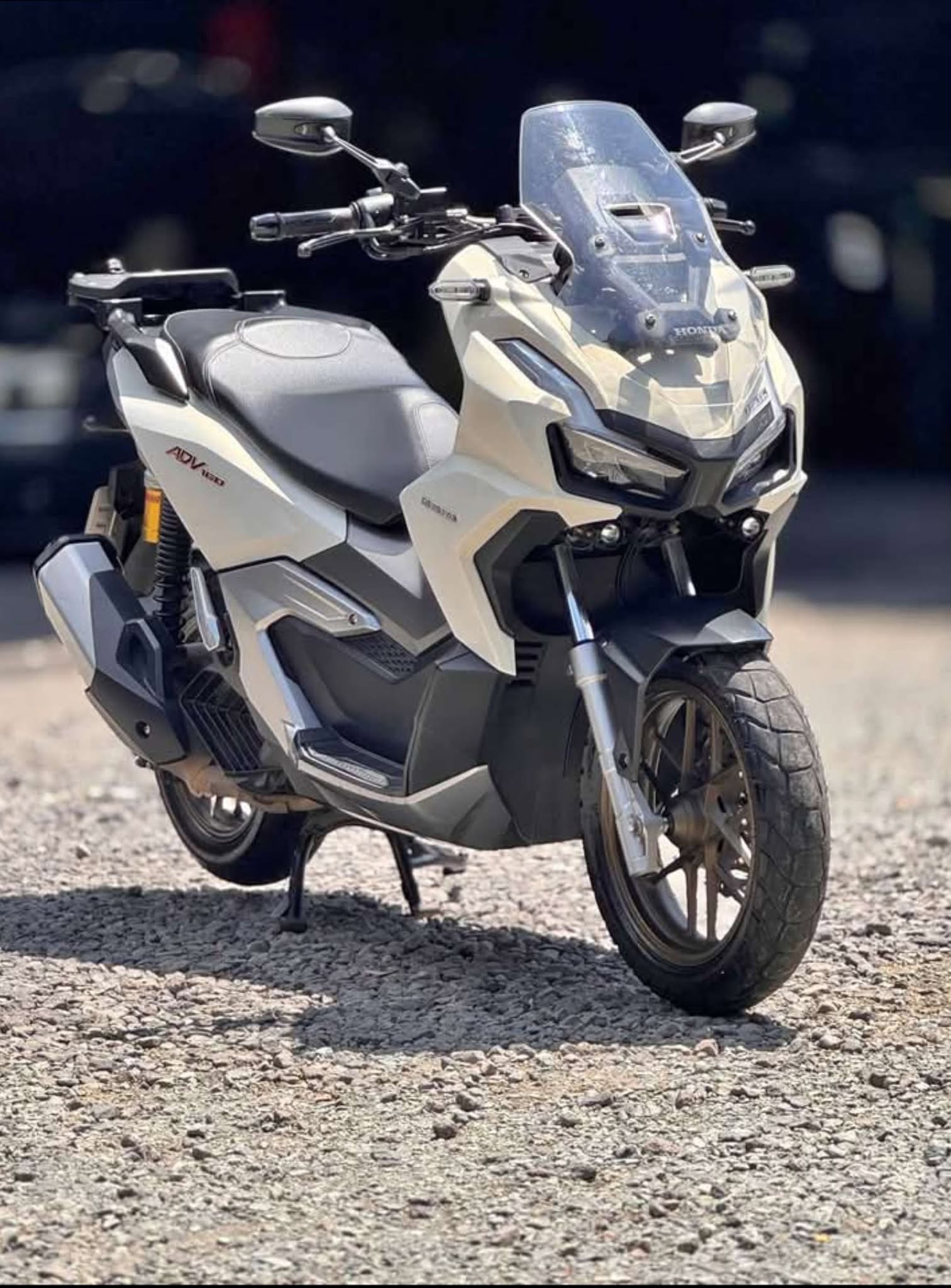 Blue adventure motorcycle model A3 equipped for off-road trails with rugged tires